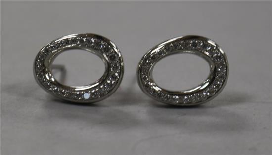 A modern pair of platinum and diamond oval openwork earrings, 13mm.
